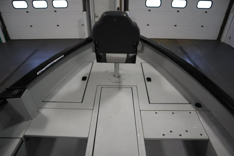 Slide: The Image of 2017 Lowe 1610 FM boat interior with seating and storage compartments. - 10