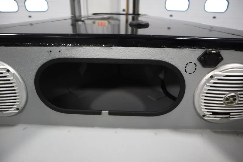 Slide: The Image of 2017 Lowe 1610 FM boat dashboard with speaker system and storage compartment. - 11