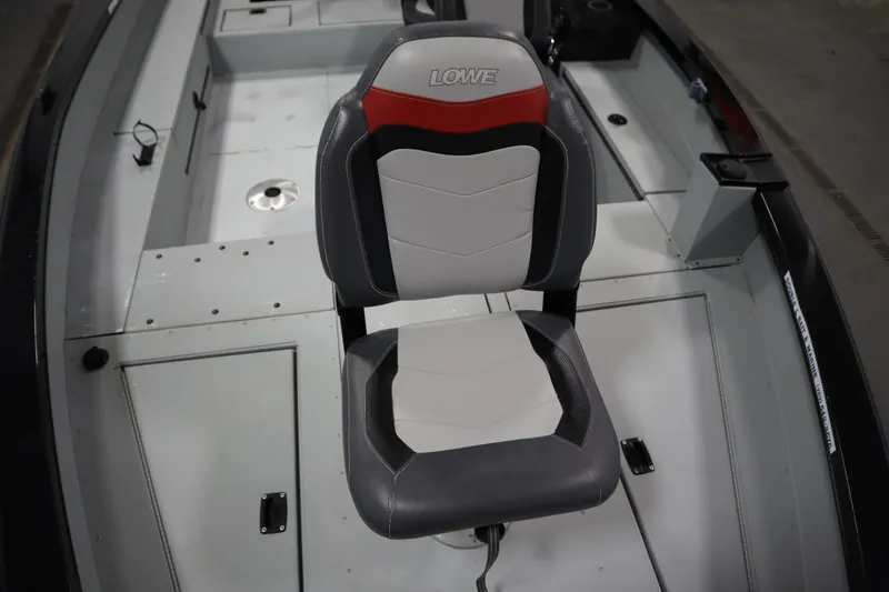 Slide: The Image of 2017 Lowe 1610 FM boat interior with a cushioned seat and storage compartments. - 12