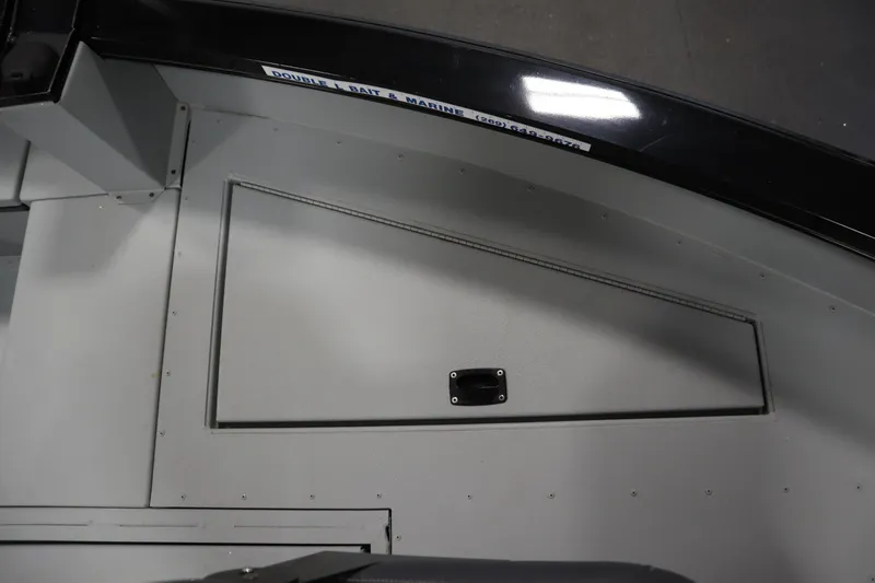 Slide: The Image of 2017 Lowe 1610 FM boat interior with storage compartment and sleek design. - 13