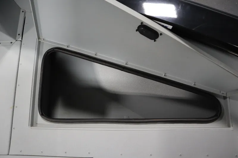 Slide: The Image of Open storage compartment in 2017 Lowe 1610 FM boat interior. - 14