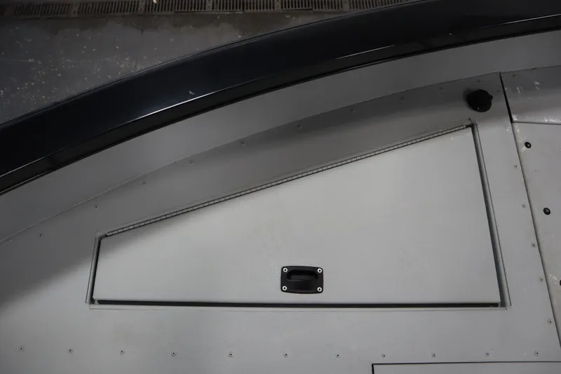 Slide: The Image of 2017 Lowe 1610 FM boat interior storage compartment with handle. - 15