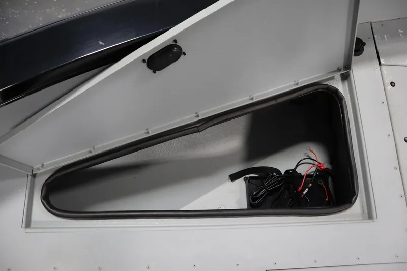 Slide: The Image of Open storage compartment in 2017 Lowe 1610 FM boat with wiring inside. - 16