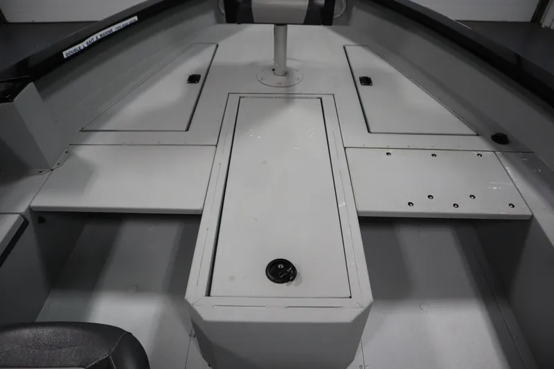 Slide: The Image of 2017 Lowe 1610 FM boat interior with storage compartments and seating. - 18