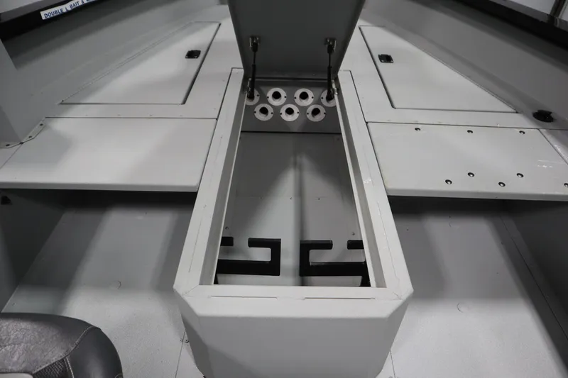 Slide: The Image of 2017 Lowe 1610 FM boat interior with storage compartments and rod holders. - 19