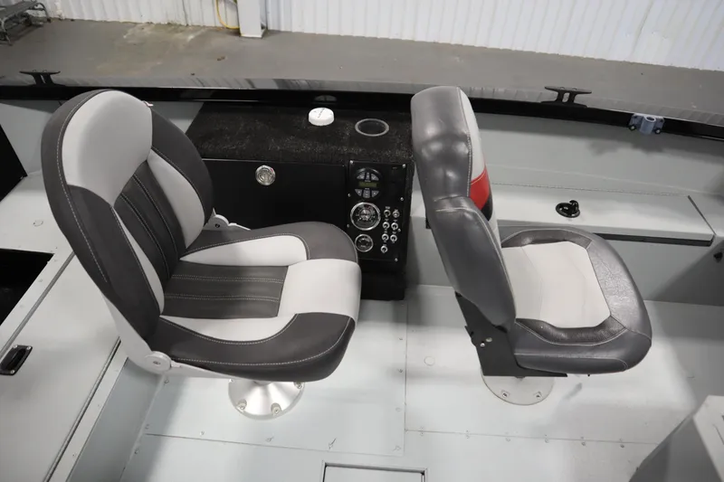 Slide: The Image of 2017 Lowe 1610 FM boat interior with two cushioned seats and control panel. - 23