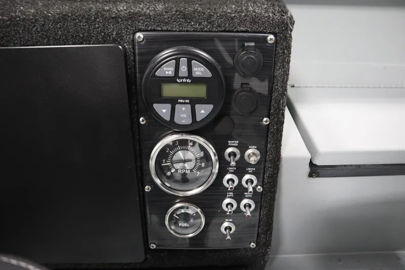 Slide: The Image of Control panel of a 2017 Lowe 1610 FM boat with gauges and switches. - 24