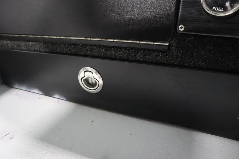 Slide: The Image of 2017 Lowe 1610 FM boat interior with fuel gauge and latch detail. - 27