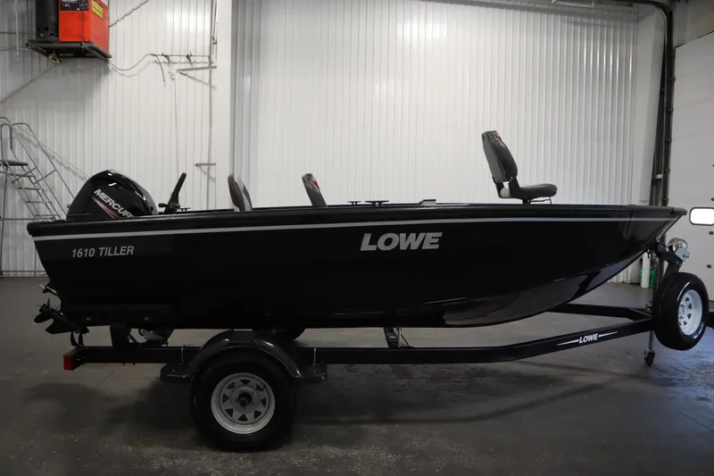 Slide: The Image of 2017 Lowe 1610 FM boat on trailer in indoor setting. - 3