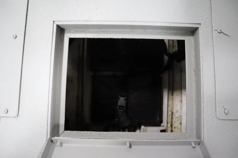 Slide: The Image of Hatch opening on a 2017 Lowe 1610 FM boat, showing interior compartment. - 30