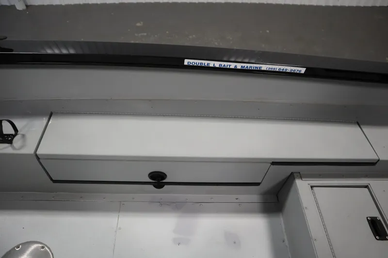 Slide: The Image of 2017 Lowe 1610 FM boat interior with storage compartment and marine equipment. - 31