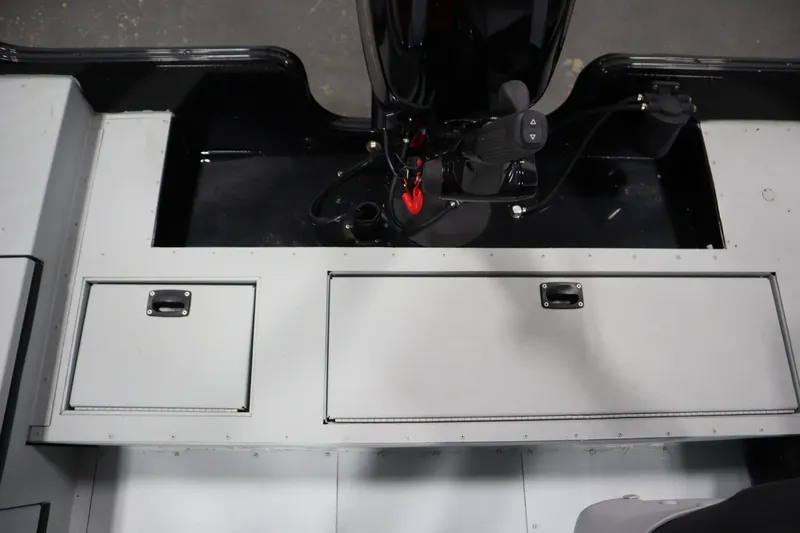 Slide: The Image of 2017 Lowe 1610 FM boat interior with storage compartments and control panel. - 33