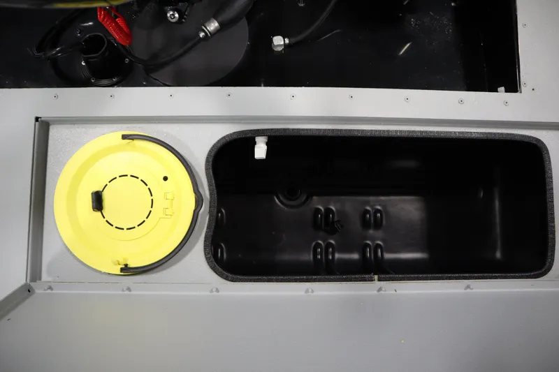 Slide: The Image of 2017 Lowe 1610 FM boat compartment with yellow lid and storage area. - 34