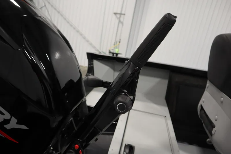 Slide: The Image of 2017 Lowe 1610 FM boat interior with motor and control handle. - 36