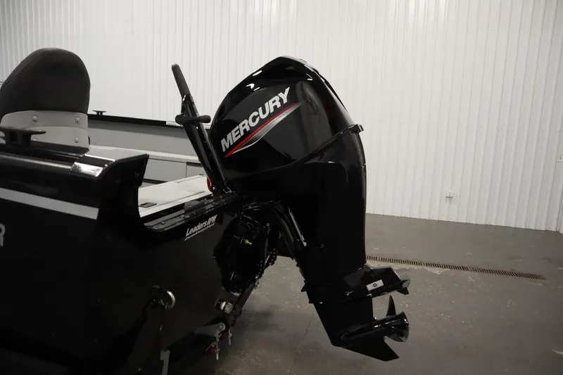 Slide: The Image of 2017 Lowe 1610 FM boat with Mercury outboard motor in a garage setting. - 37