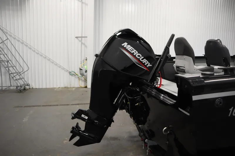 Slide: The Image of 2017 Lowe 1610 FM boat with Mercury outboard motor in a garage setting. - 38