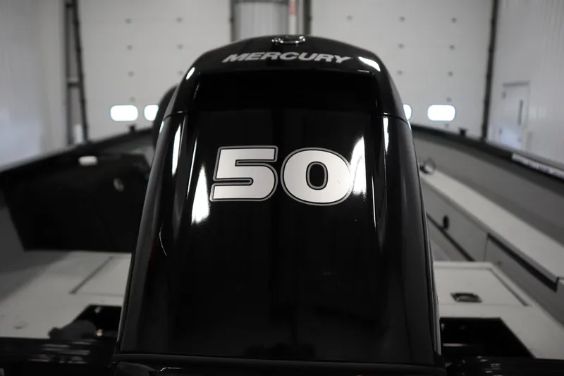 Slide: The Image of 2017 Lowe 1610 FM boat with Mercury 50 horsepower engine in a garage. - 39