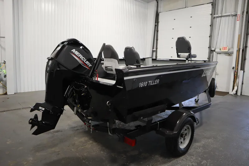 Slide: The Image of 2017 Lowe 1610 FM boat with Mercury outboard motor in a garage setting. - 4