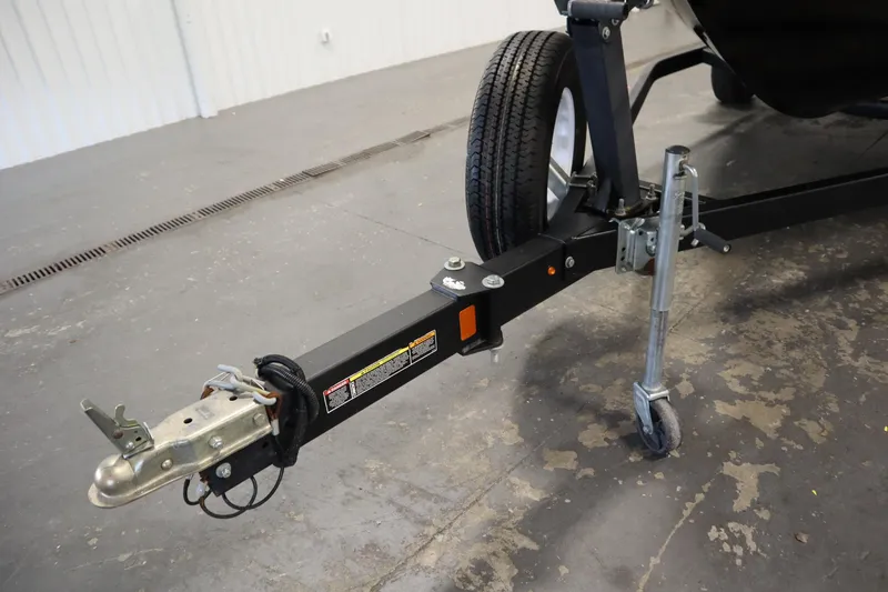 Slide: The Image of 2017 Lowe 1610 FM trailer hitch with wheel jack in a garage setting. - 41