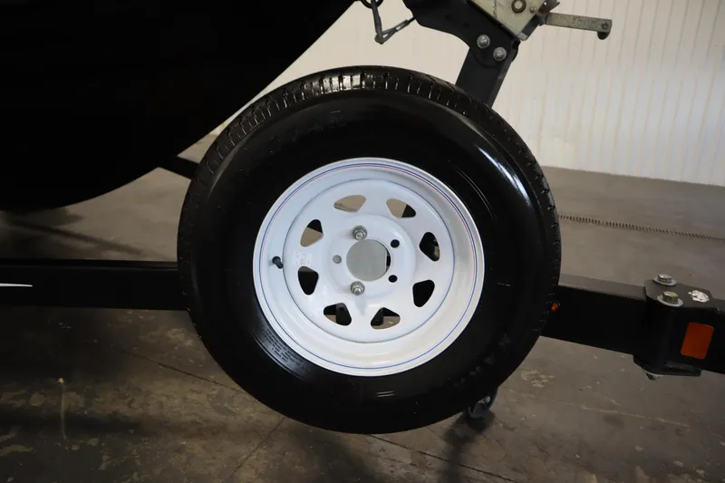 Slide: The Image of Close-up of a 2017 Lowe 1610 FM trailer wheel with white rim. - 42