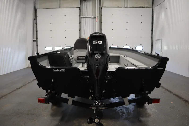 Slide: The Image of 2017 Lowe 1610 FM boat with 50 HP motor in a garage setting. - 5