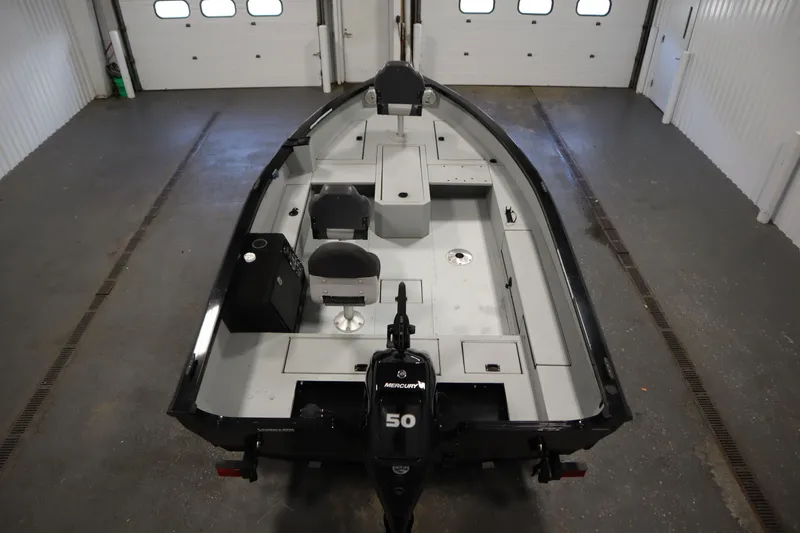 Slide: The Image of 2017 Lowe 1610 FM boat in a garage, featuring a Mercury 50 engine. - 9