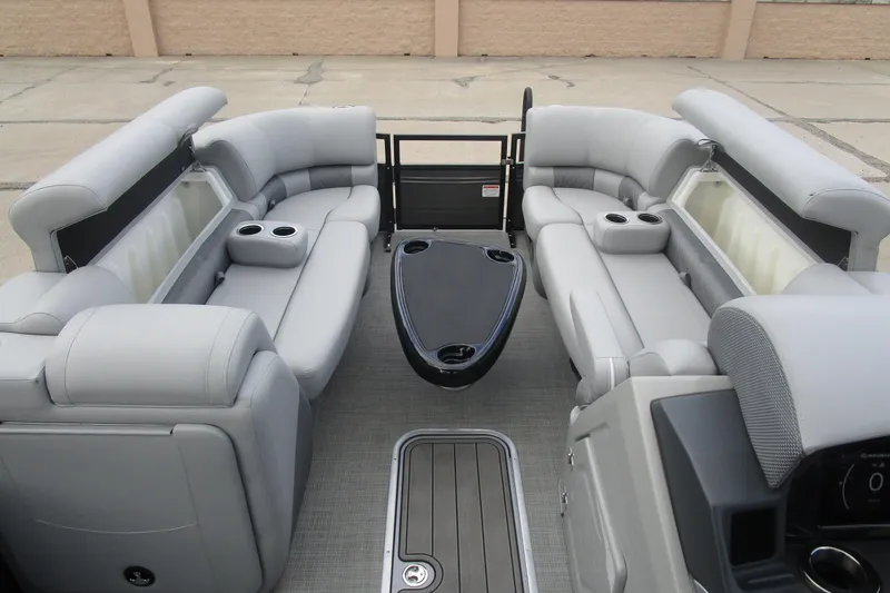 Slide: The Image of 2024 Regency 230 LE3 pontoon boat interior with luxurious gray seating and cup holders. - 13