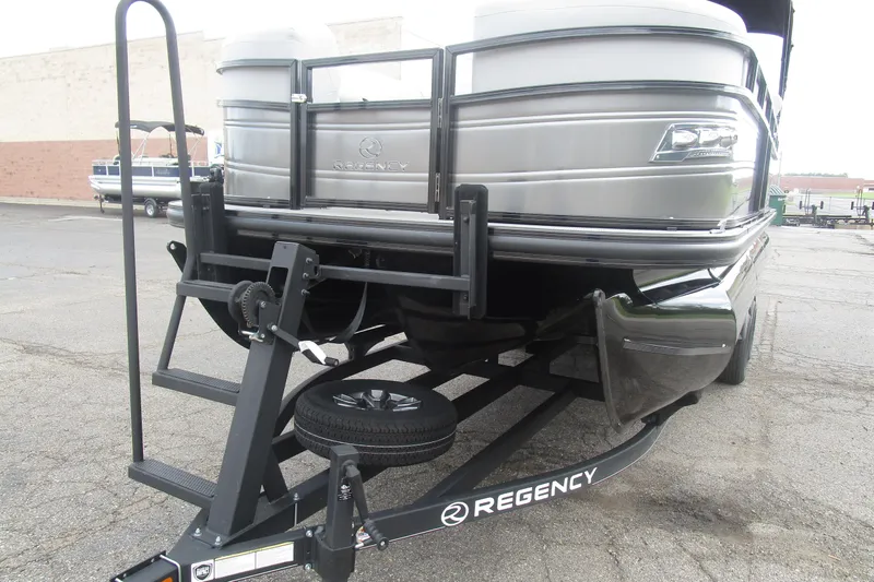 Slide: The Image of 2024 Regency 230 LE3 pontoon boat on trailer, showcasing sleek design and sturdy build. - 4