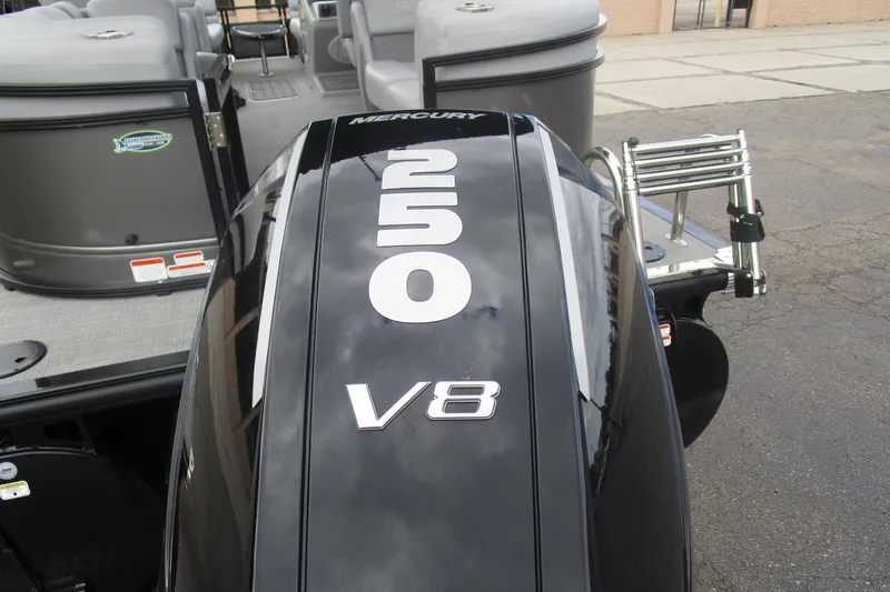 Slide: The Image of 2024 Regency 230 LE3 with Mercury V8 outboard engine, rear view. - 6