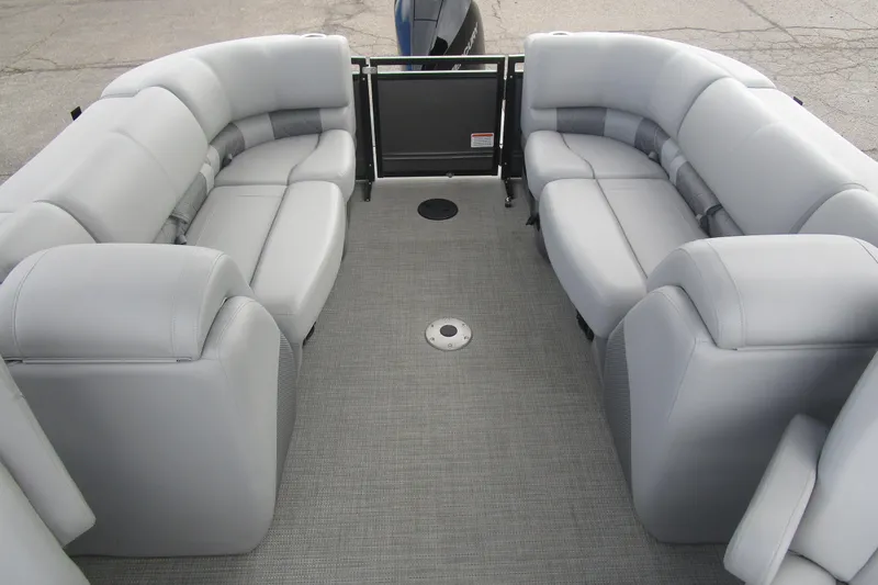 Slide: The Image of 2024 Regency 230 LE3 pontoon boat interior with plush gray seating and spacious layout. - 7
