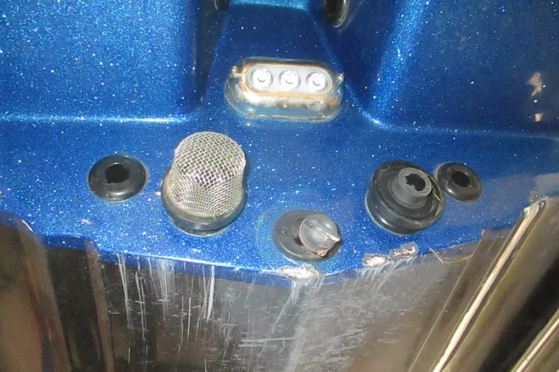 Slide: The Image of Close-up of 2024 Nitro Z20 boat's blue metallic hull with fittings and mesh cover. - 20