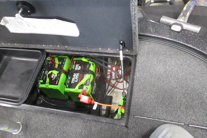 Slide: The Image of 2024 Nitro Z20 boat battery compartment with green batteries and wiring. - 6