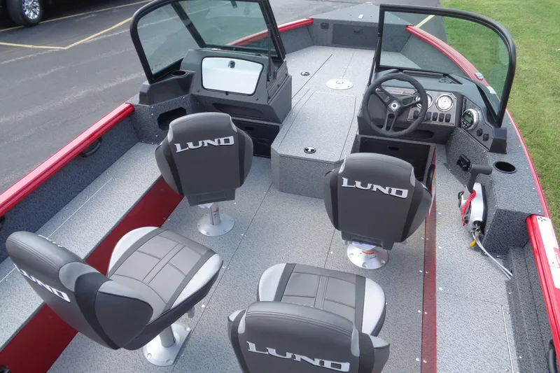 Slide: The Image of 2026 Lund 1800 Explorer Sport boat interior with four seats and modern dashboard. - 12