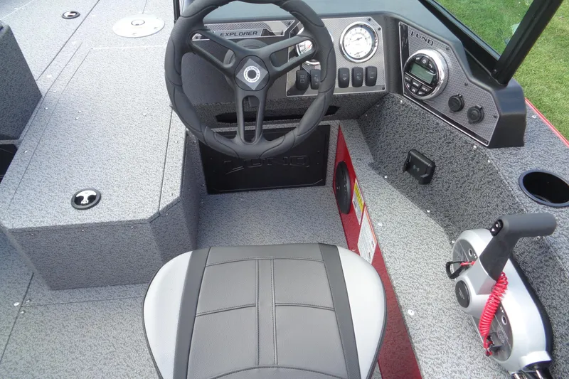 Slide: The Image of 2026 Lund 1800 Explorer Sport boat interior with steering wheel and control panel. - 13