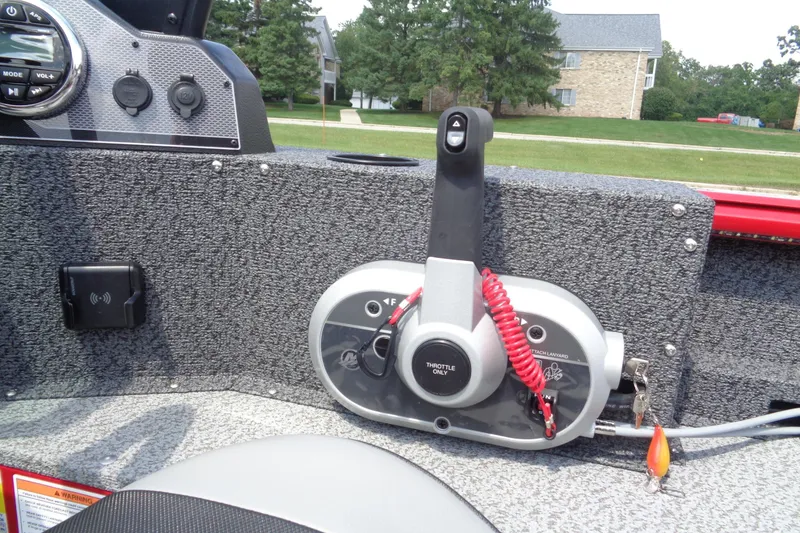 Slide: The Image of Control panel of 2026 Lund 1800 Explorer Sport boat with throttle and switches. - 17