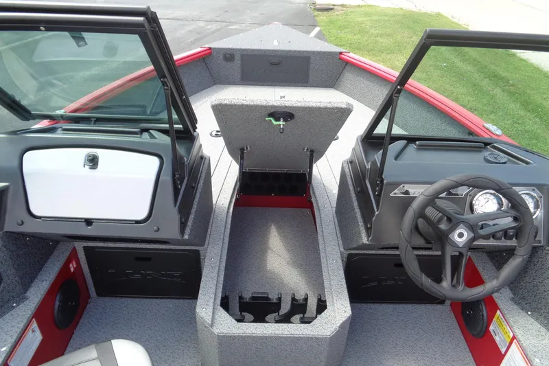 Slide: The Image of 2026 Lund 1800 Explorer Sport boat interior with steering wheel and storage compartments. - 18