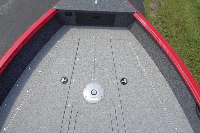 Slide: The Image of 2026 Lund 1800 Explorer Sport boat deck with red trim and storage compartments. - 19