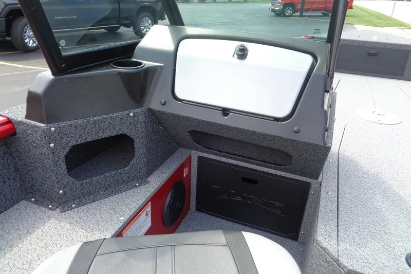 Slide: The Image of 2026 Lund 1800 Explorer Sport boat interior with storage compartments and seating. - 23