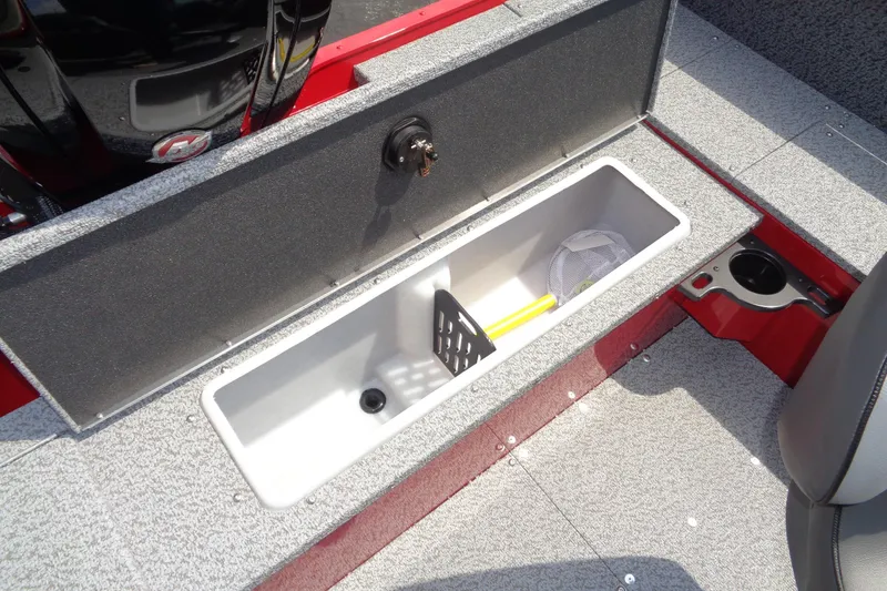 Slide: The Image of 2026 Lund 1800 Explorer Sport boat storage compartment with fishing net and paddle. - 25