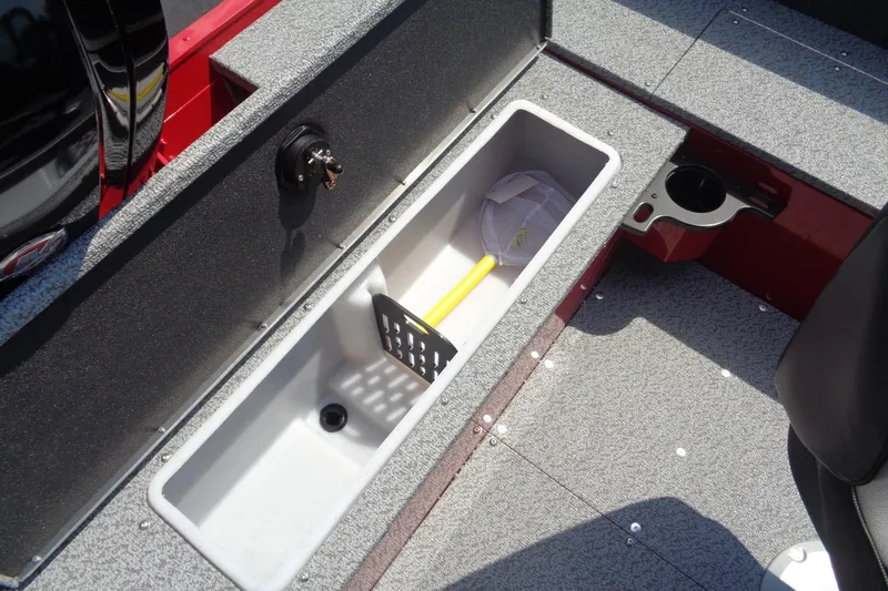 Slide: The Image of 2026 Lund 1800 Explorer Sport boat interior with storage compartment and fishing net. - 26