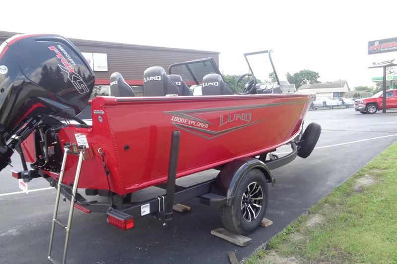 Slide: The Image of 2026 Lund 1800 Explorer Sport boat in vibrant red on a trailer. - 7