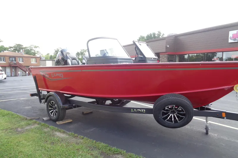 Slide: The Image of 2026 Lund 1800 Explorer Sport boat in vibrant red on a trailer. - 9