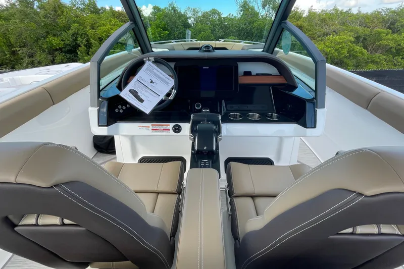 Slide: The Image of Interior view of 2026 Monterey 30 ELITE boat cockpit with modern controls and seating. - 13