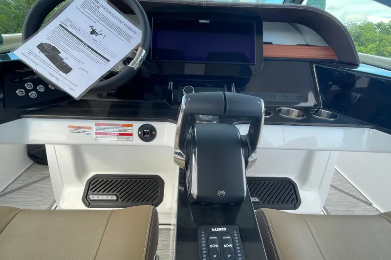 Slide: The Image of Cockpit of 2026 Monterey 30 ELITE boat with modern controls and steering wheel. - 14
