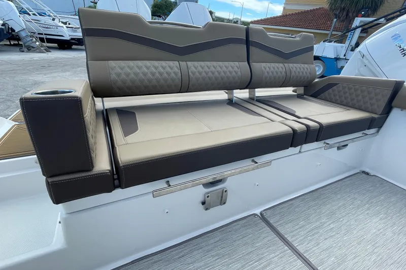 Slide: The Image of Luxury seating on 2026 Monterey 30 ELITE boat with modern design and cup holder. - 16