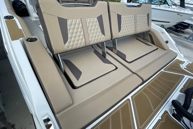 Slide: The Image of 2026 Monterey 30 ELITE boat with luxurious tan seating and cup holders. - 18