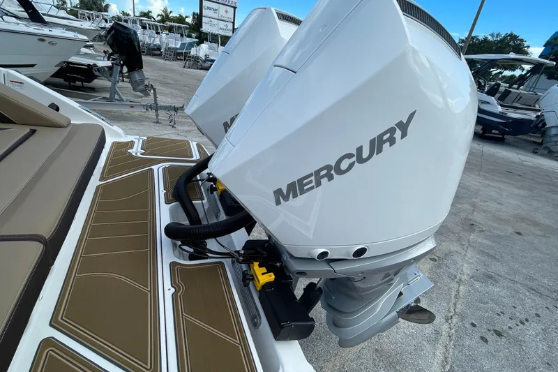 Slide: The Image of 2026 Monterey 30 ELITE boat with dual Mercury outboard engines at a marina. - 19