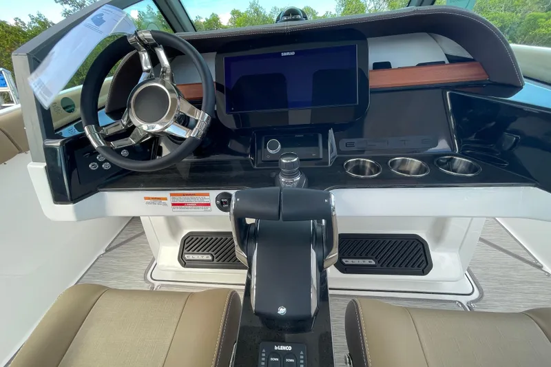 Slide: The Image of 2026 Monterey 30 ELITE boat dashboard with steering wheel, touchscreen, and control panel. - 3