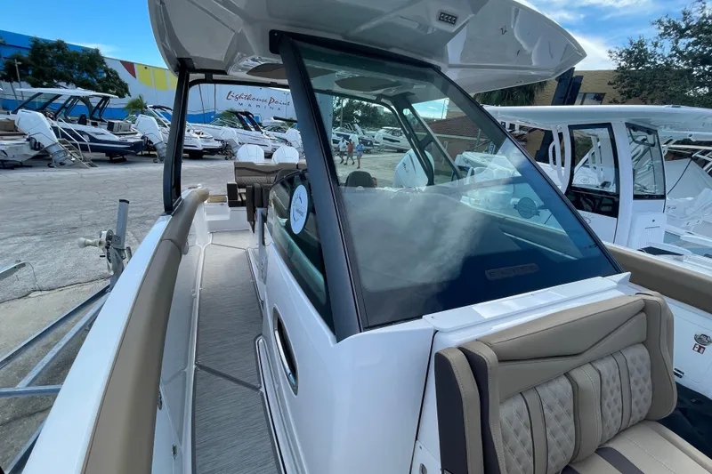 Slide: The Image of 2026 Monterey 30 ELITE boat at marina, showcasing sleek design and luxurious seating. - 7