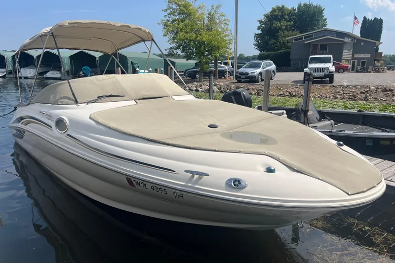 The Image of 2001 Sea Ray 240 Sundancer boat docked at marina with canopy and cover. - 0